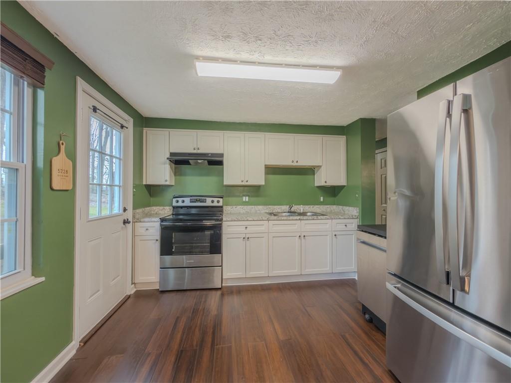 5728 Salem Road Lithonia, GA 30038 - Photo 11 of 35 a kitchen with a refrigerator and a stove top oven