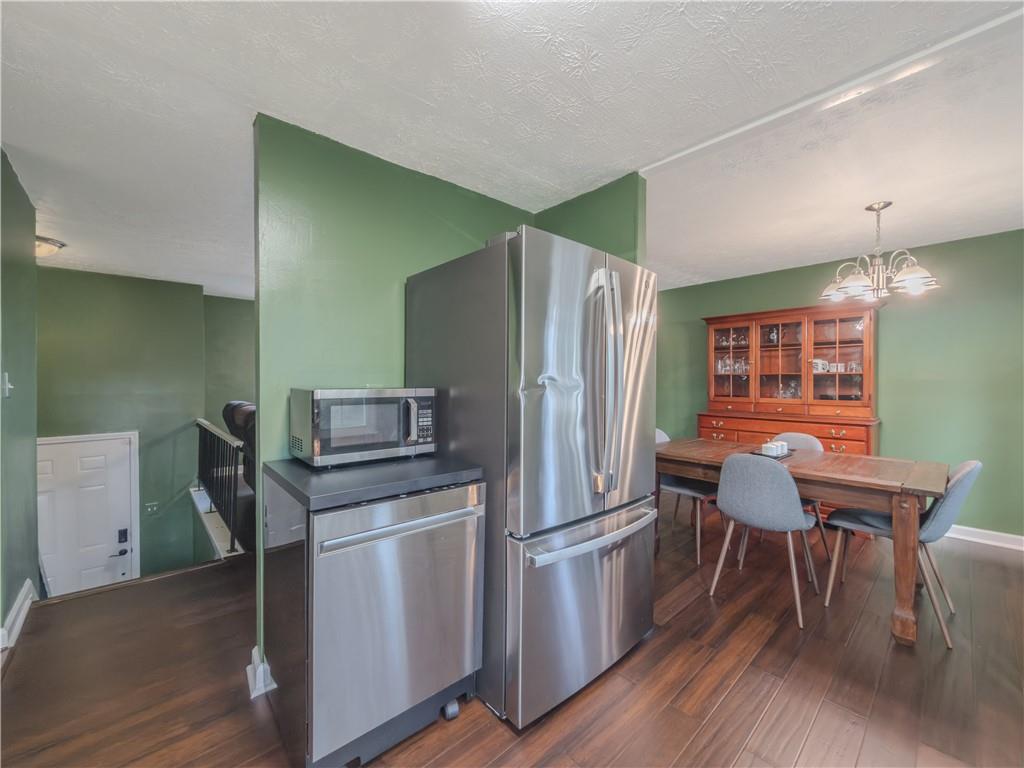 5728 Salem Road Lithonia, GA 30038 - Photo 12 of 35 a kitchen with stainless steel appliances wooden floor and chair