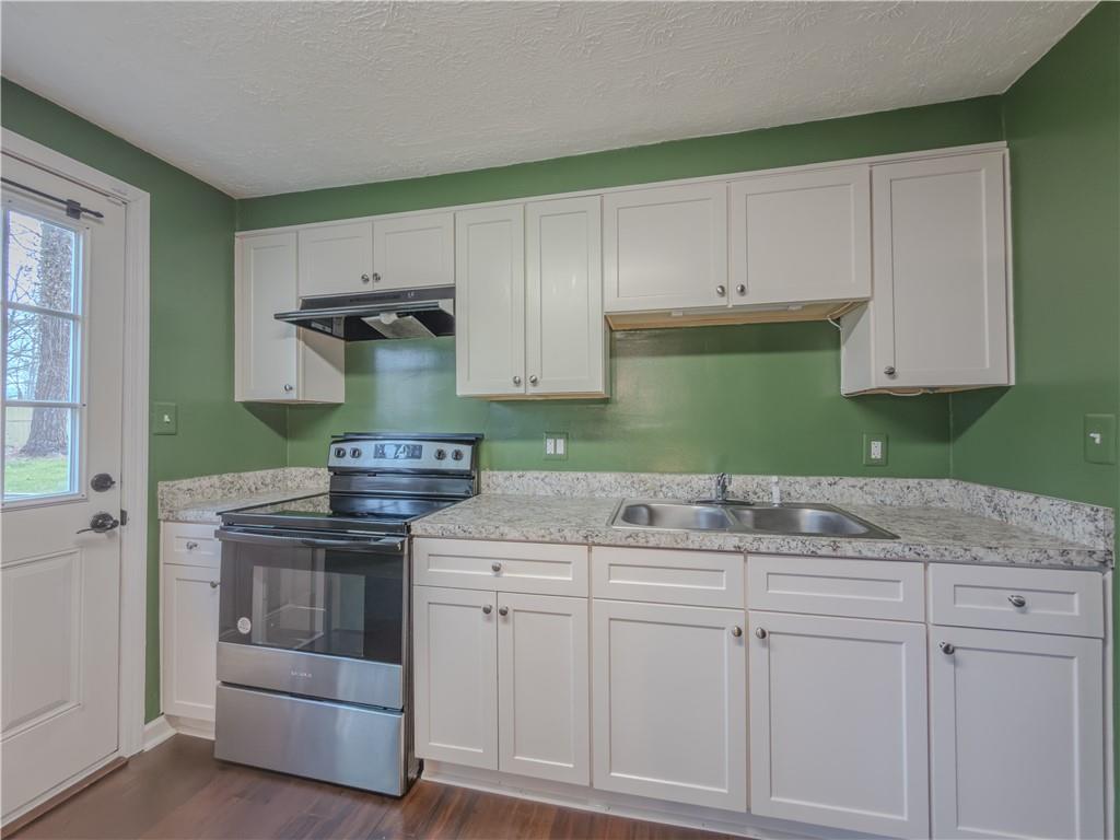 5728 Salem Road Lithonia, GA 30038 - Photo 13 of 35 a kitchen with granite countertop white cabinets and a stove