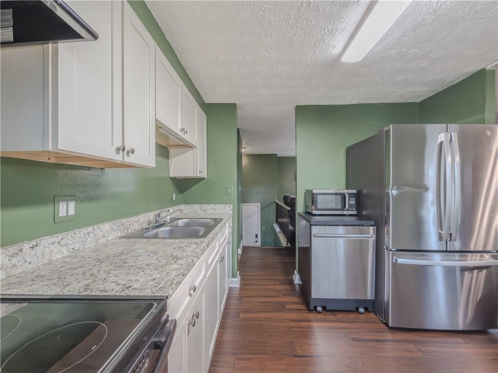 5728 Salem Road Lithonia, GA 30038 - Photo 14 of 35 a kitchen with a refrigerator a sink and a stove