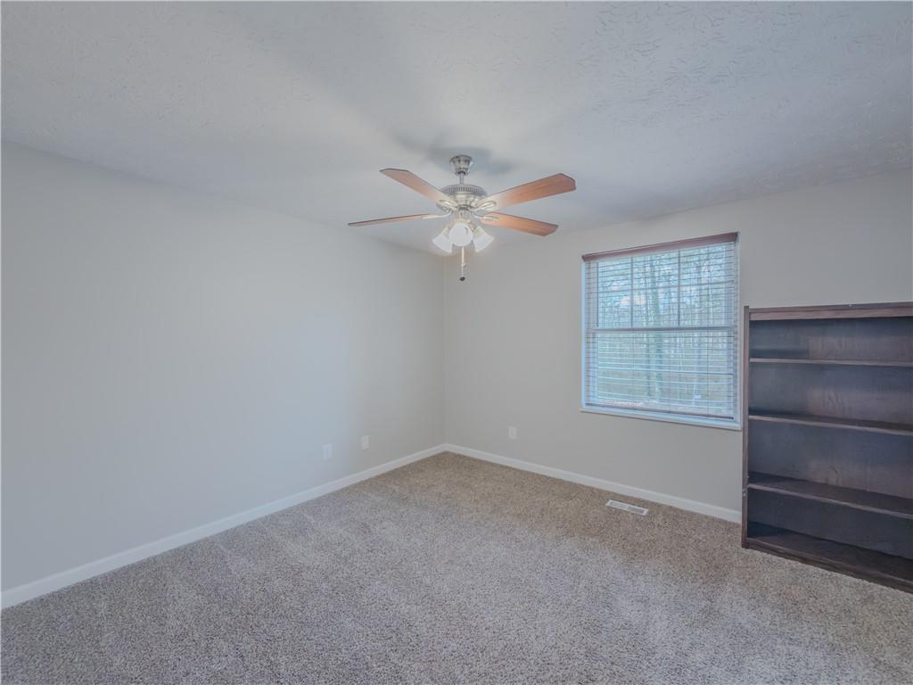 5728 Salem Road Lithonia, GA 30038 - Photo 15 of 35 an empty room with windows and fan