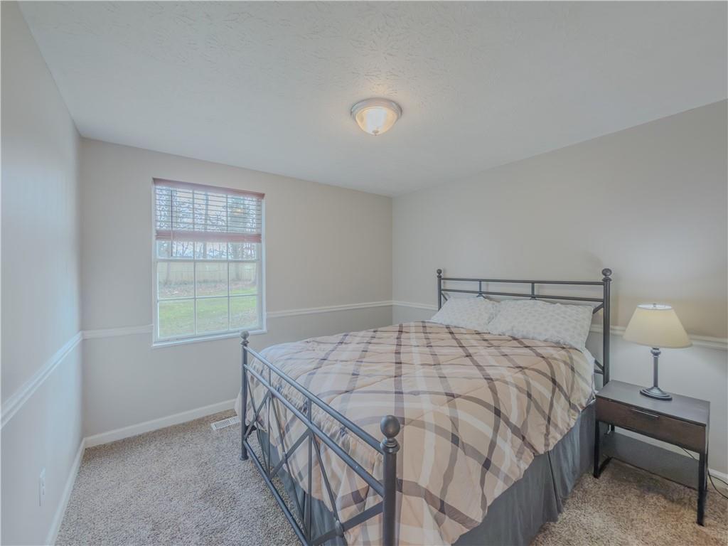 5728 Salem Road Lithonia, GA 30038 - Photo 17 of 35 a bedroom with a bed and a window