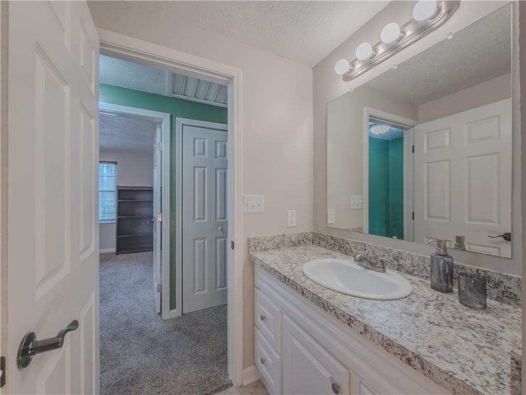 5728 Salem Road Lithonia, GA 30038 - Photo 21 of 35 a bathroom with a granite countertop sink and a mirror