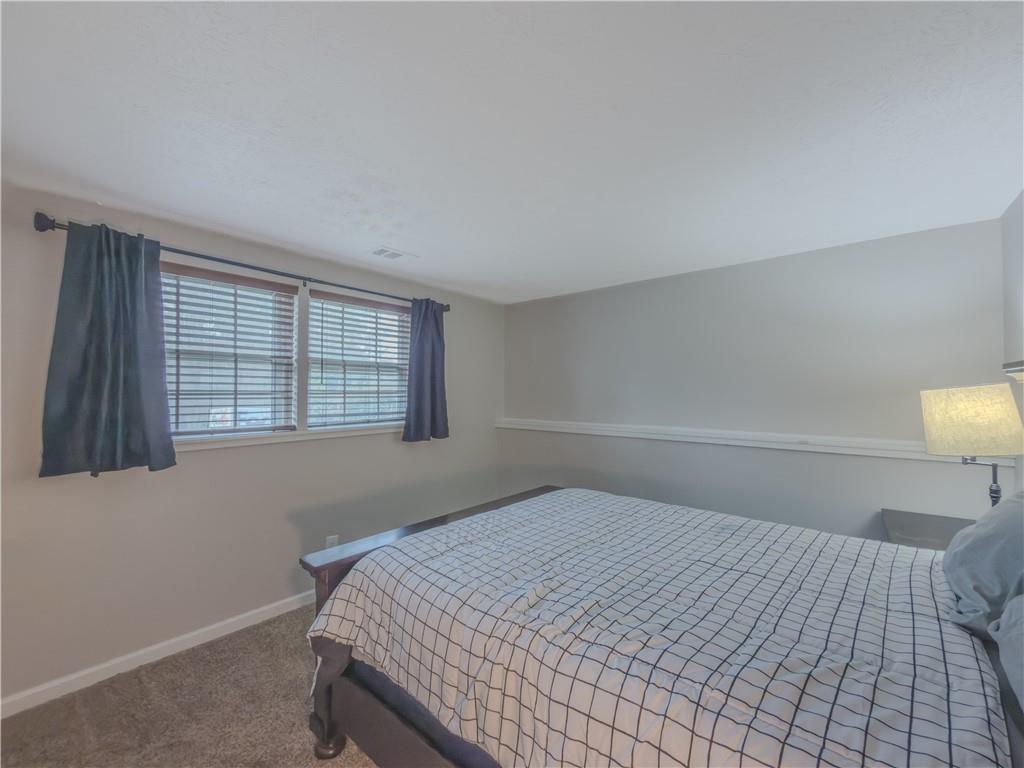 5728 Salem Road Lithonia, GA 30038 - Photo 23 of 35 a bedroom with a bed and a lamp next to a window