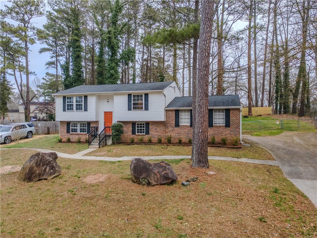 5728 Salem Road Lithonia, GA 30038 - Photo 3 of 35 a view of a house with backyard and trees