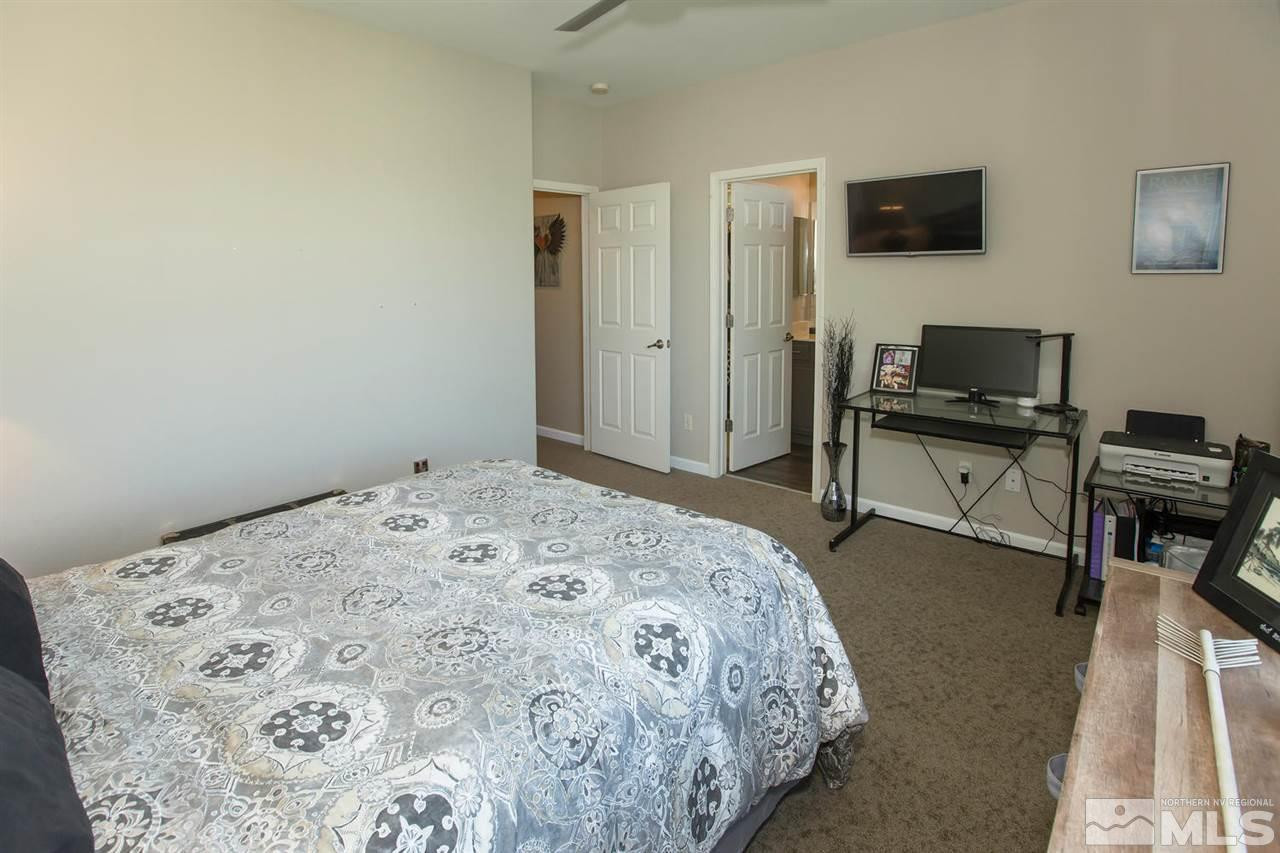 11003 Lamour Lane Reno, NV 89521 - Photo 8 of 23 a bedroom with a bed and a flat screen tv