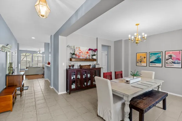 a view of a dining room with furniture and chandelier
