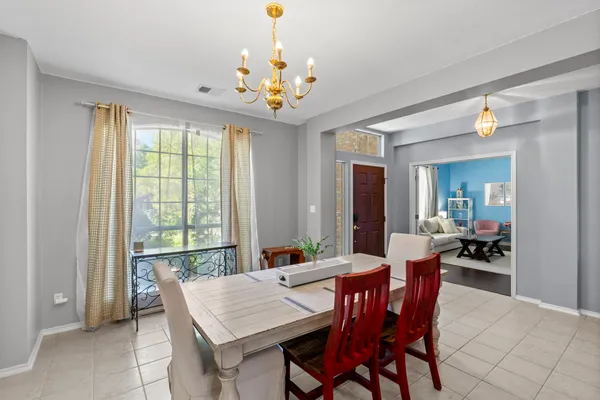 a view of a dining room with furniture and a chandelier