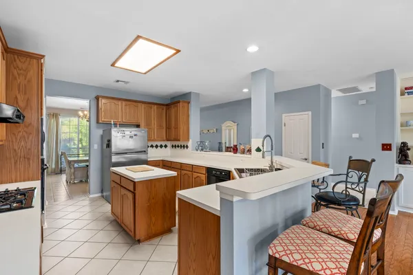 a large kitchen with a large counter top appliances and cabinets