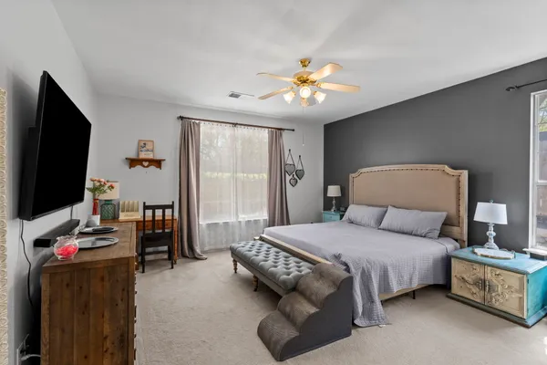 a bedroom with a bed and a flat screen tv