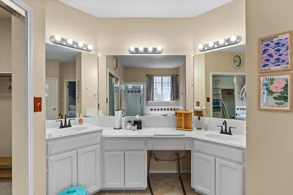 a bathroom with a sink double vanity and a mirror