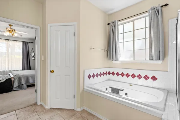 a bathroom with a bathtub and a window