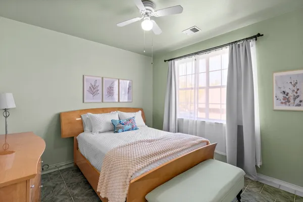 a bedroom with a large bed and a chandelier