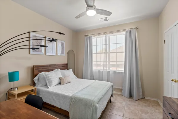 a bedroom with a bed and a chandelier
