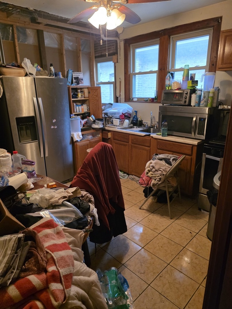 9250 South Ada Street Chicago, IL 60620 - Photo 2 of 16 a bedroom with furniture and a window