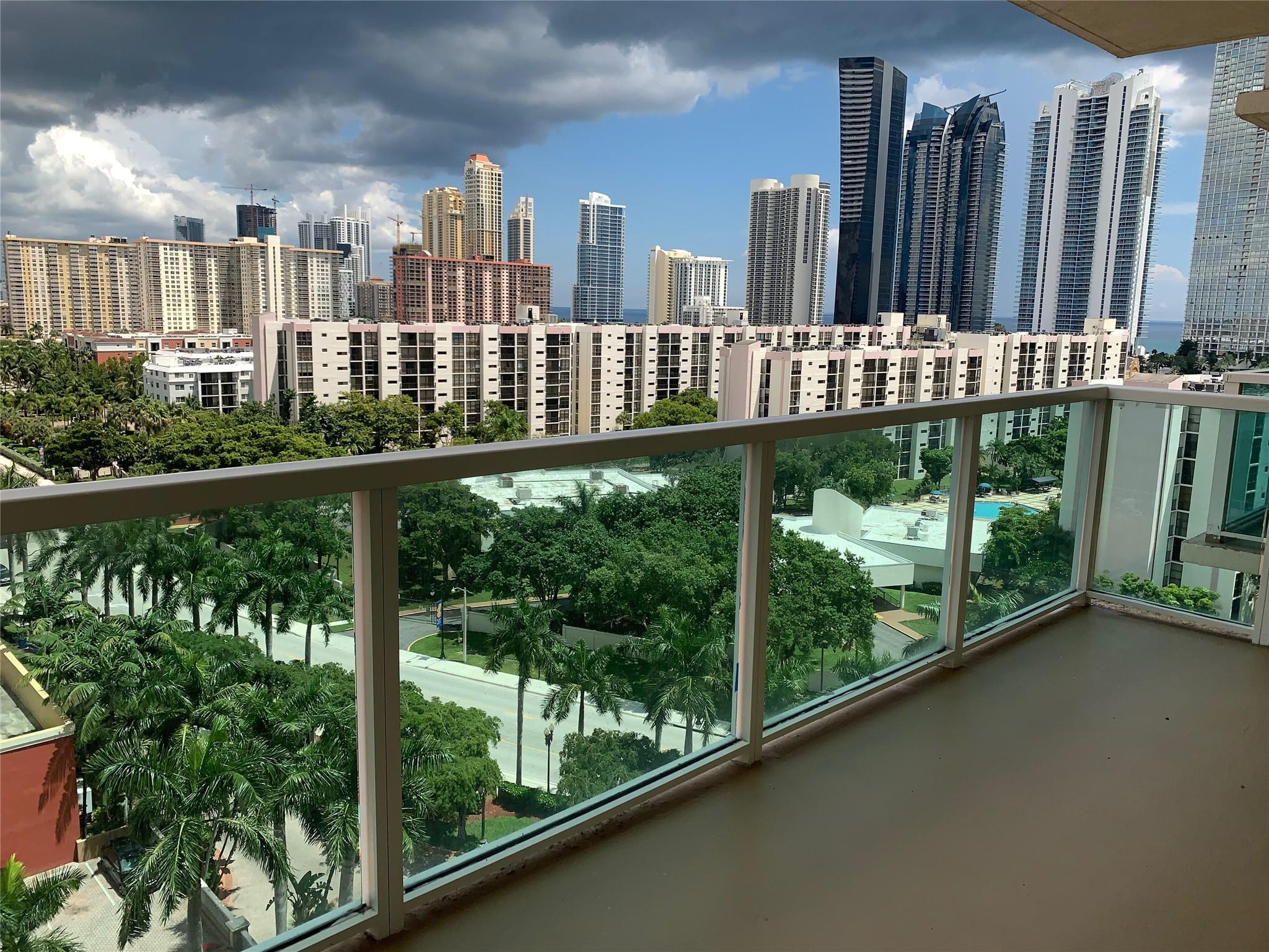 16900 North Bay Road, Unit 3514 Sunny Isles Beach, FL 33160 - Photo 6 of 27 a view of a balcony with floor to ceiling windows and wooden fence