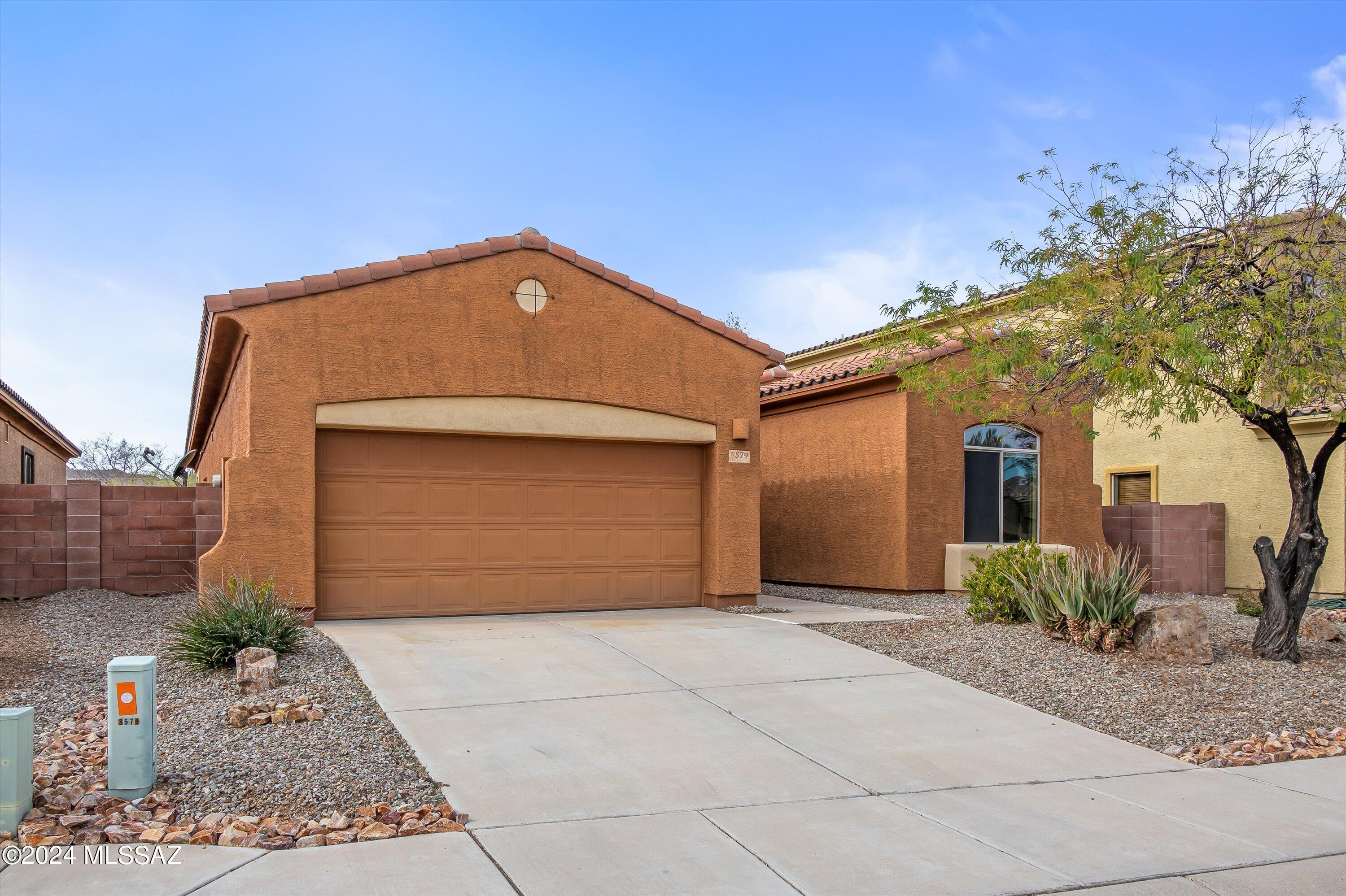 8579 North Shadow Wash Way Tucson, AZ 85743 - Photo 33 of 34 a front view of a house with a yard and garage
