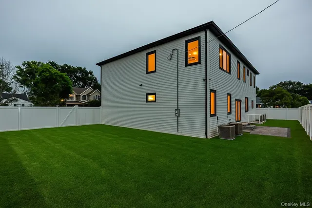 a backyard of a house with table and chairs