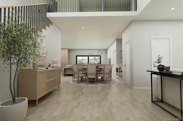 a dining room with furniture and a potted plant