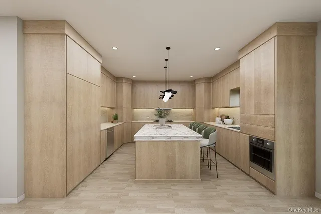 a large white kitchen with a stove a sink a refrigerator and white cabinets