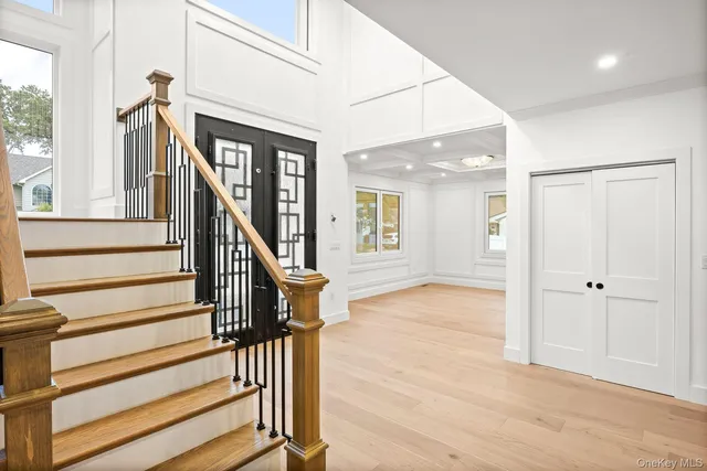 a view of an entryway with wooden floor and door