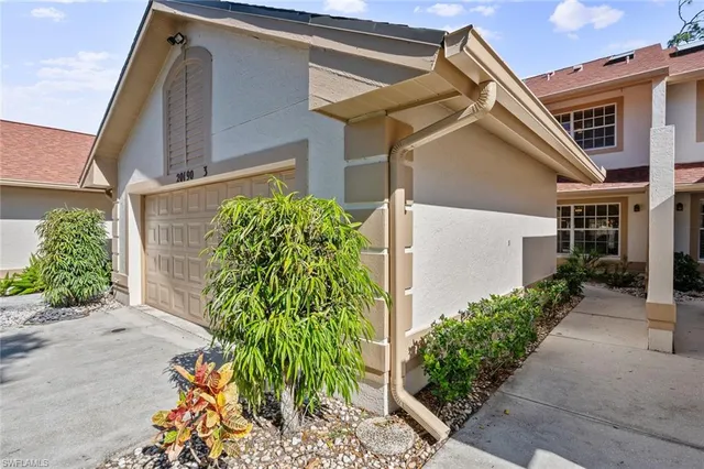 front view of a house with potted plants