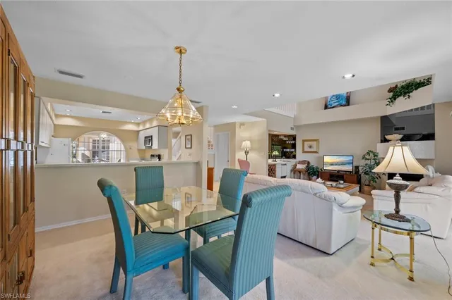 a view of a dining room with furniture and a chandelier