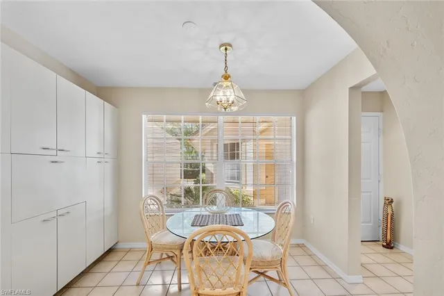 a very nice looking dining room with furniture and a chandelier