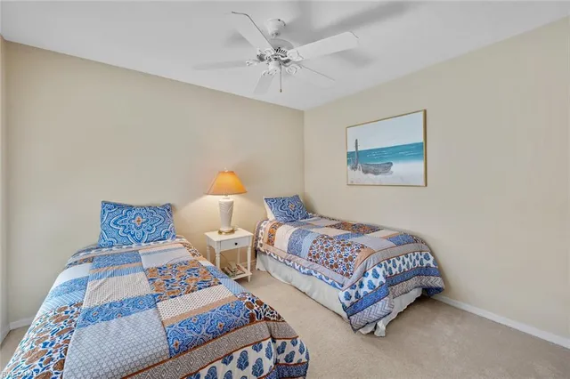 a bedroom with two beds and painting on the wall