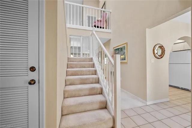 a view of staircase with white walls and a window
