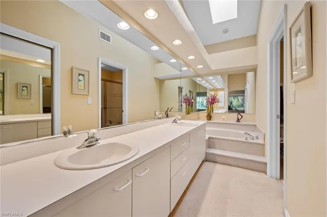 a bathroom with a sink double vanity and a mirror