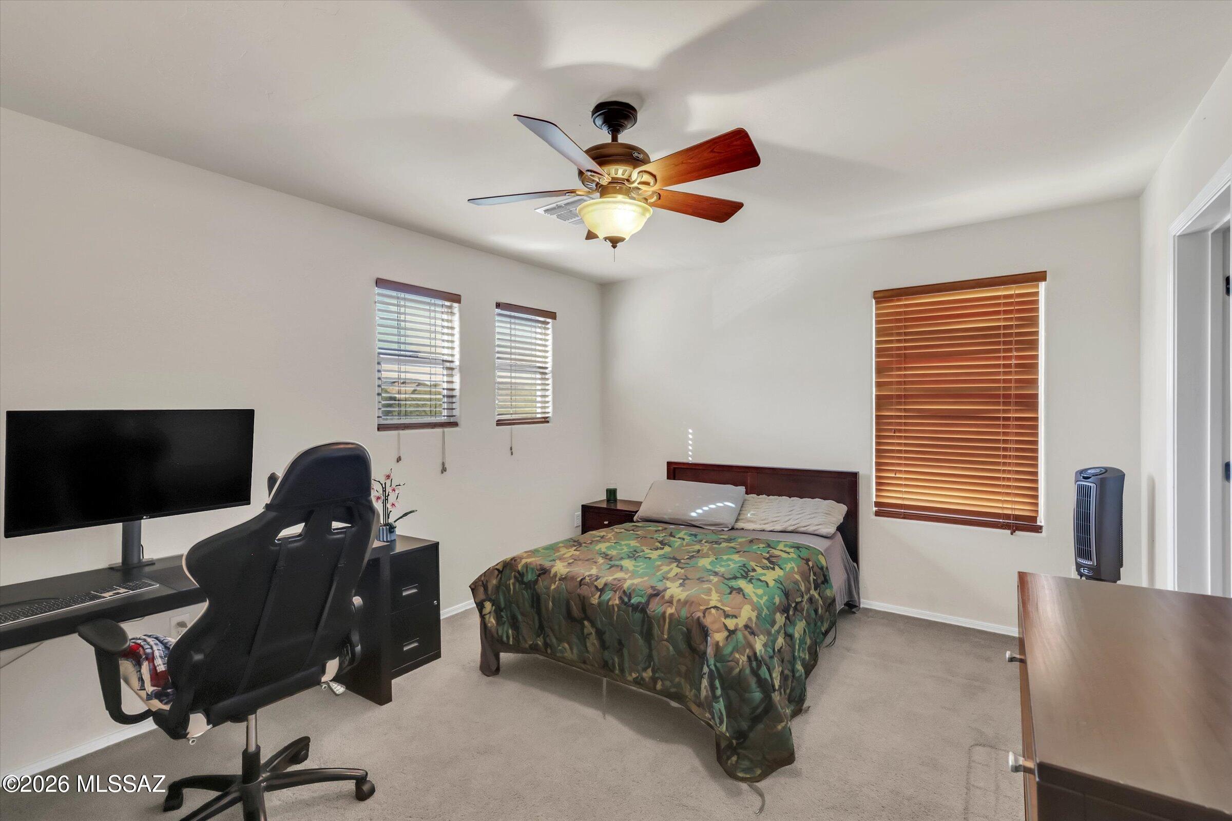 6095 South Jakemp Trail Tucson, AZ 85747 - Photo 38 of 52 a bedroom with a bed and a large window