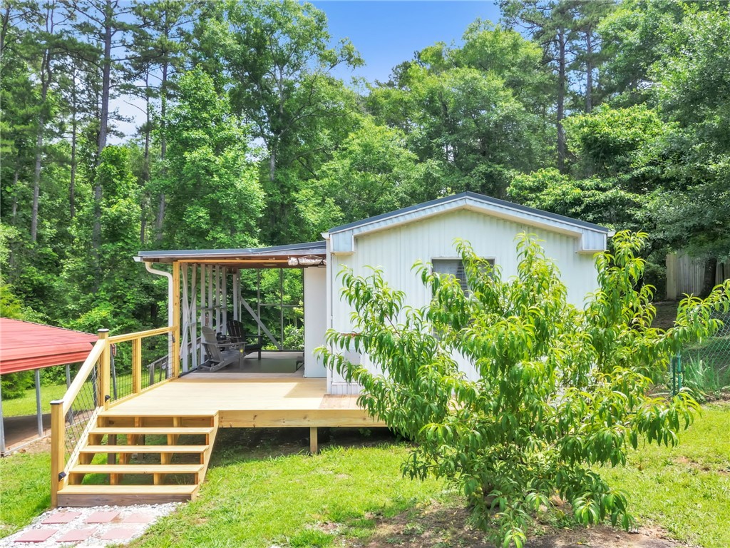 506 Charlies Creek Road Iva, SC 29655 - Photo 5 of 28 A quaint white residence with an inviting covered deck and mature surrounding trees.