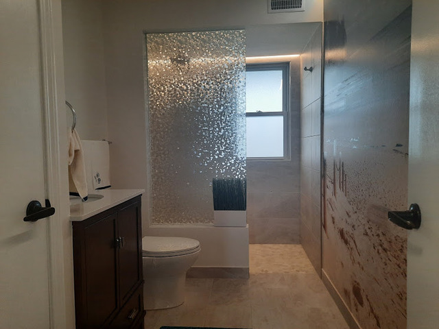 1106 Busse Road Mount Prospect, IL 60056 - Photo 21 of 27 a bathroom with a toilet a sink and shower