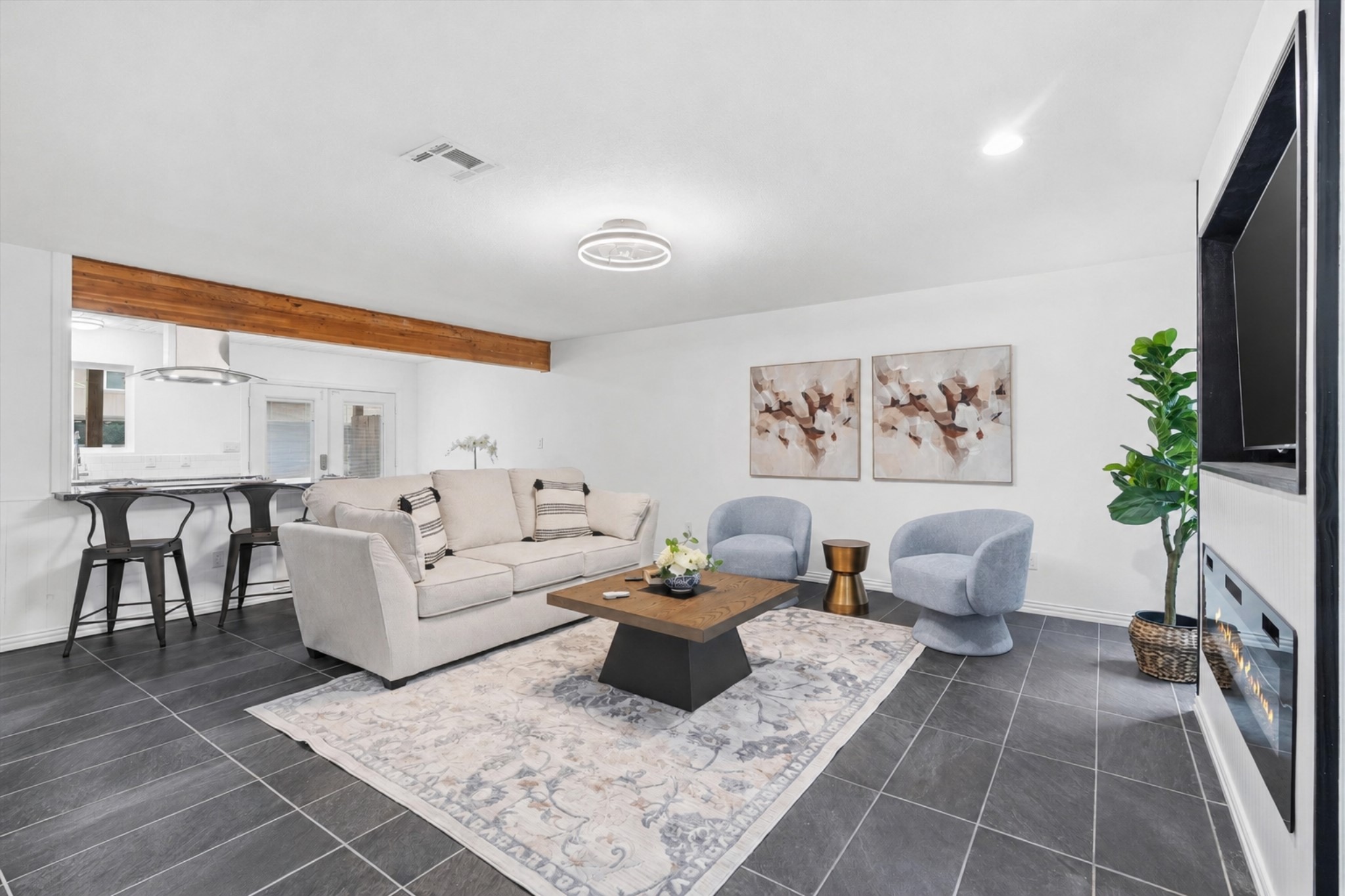 1011 Hamblen Road, Unit 306 Houston, TX 77339 - Photo 5 of 38 At the heart of the home, an open living space unfolds with wood beam accents overhead and sleek tile flooring, the kind of room that's equally good for your next big get-together.