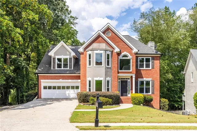 a front view of a house with a yard