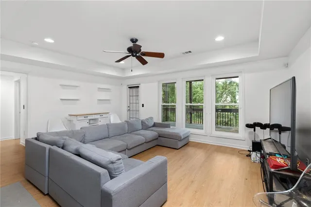 a living room with furniture and kitchen view