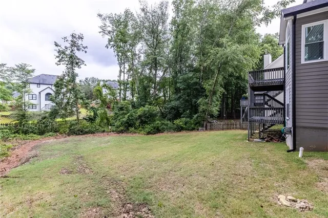 a view of backyard with deck and trees