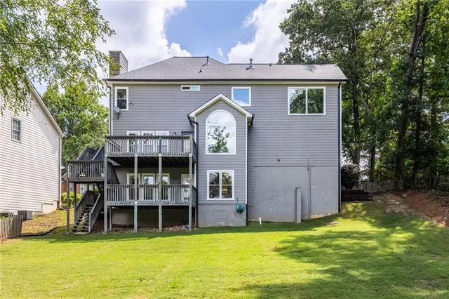an aerial view of a house with a big yard and large trees