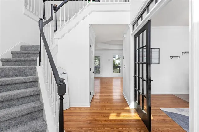 a view of entryway and hall with wooden floor