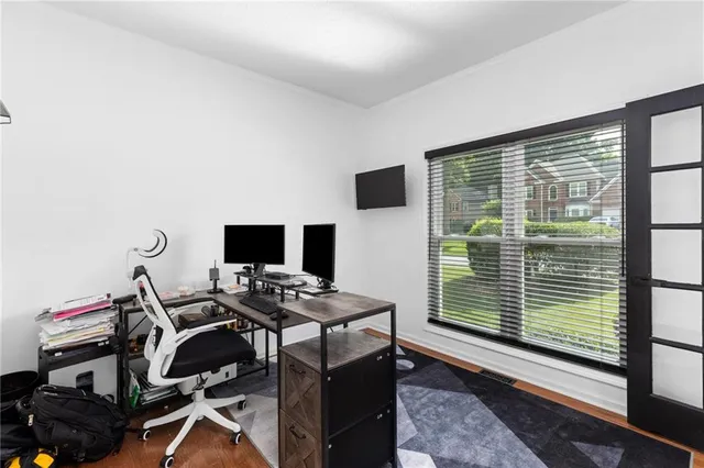 a view of a workspace with furniture and a window