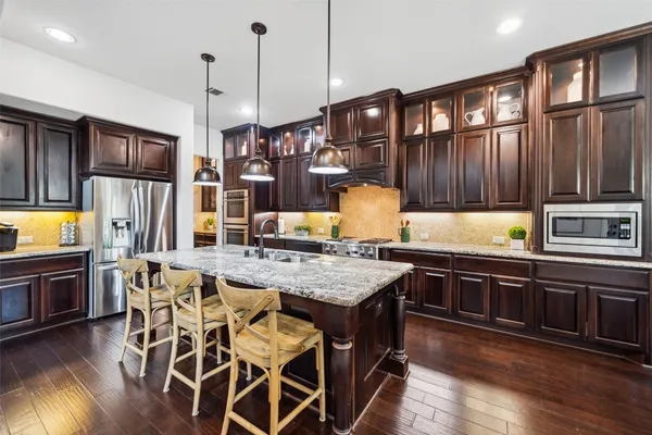 a bathroom with a granite countertop sink toilet and mirror