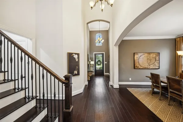 a view of an entryway with wooden floor and a livingroom