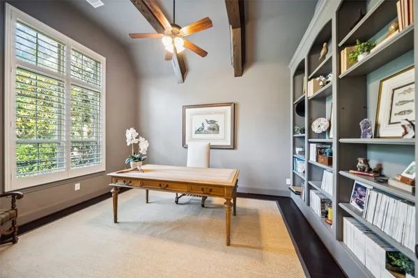 a view of a workspace with furniture and a window