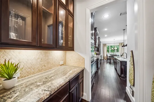 a large white kitchen with lots of counter space wooden floor and appliances