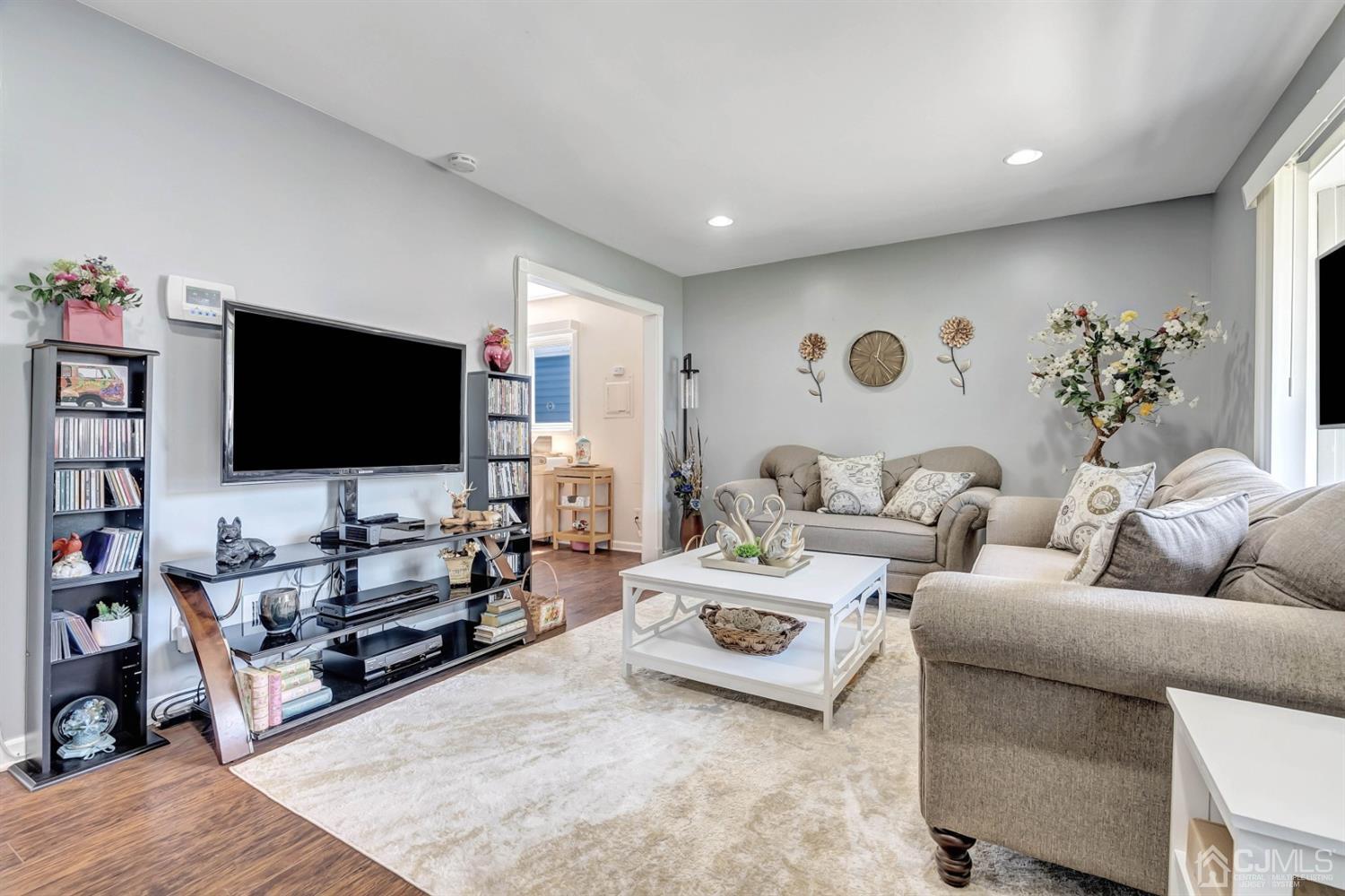 30 West Knollwood Road Edison, NJ 08817 - Photo 2 of 17 a living room with furniture and a flat screen tv