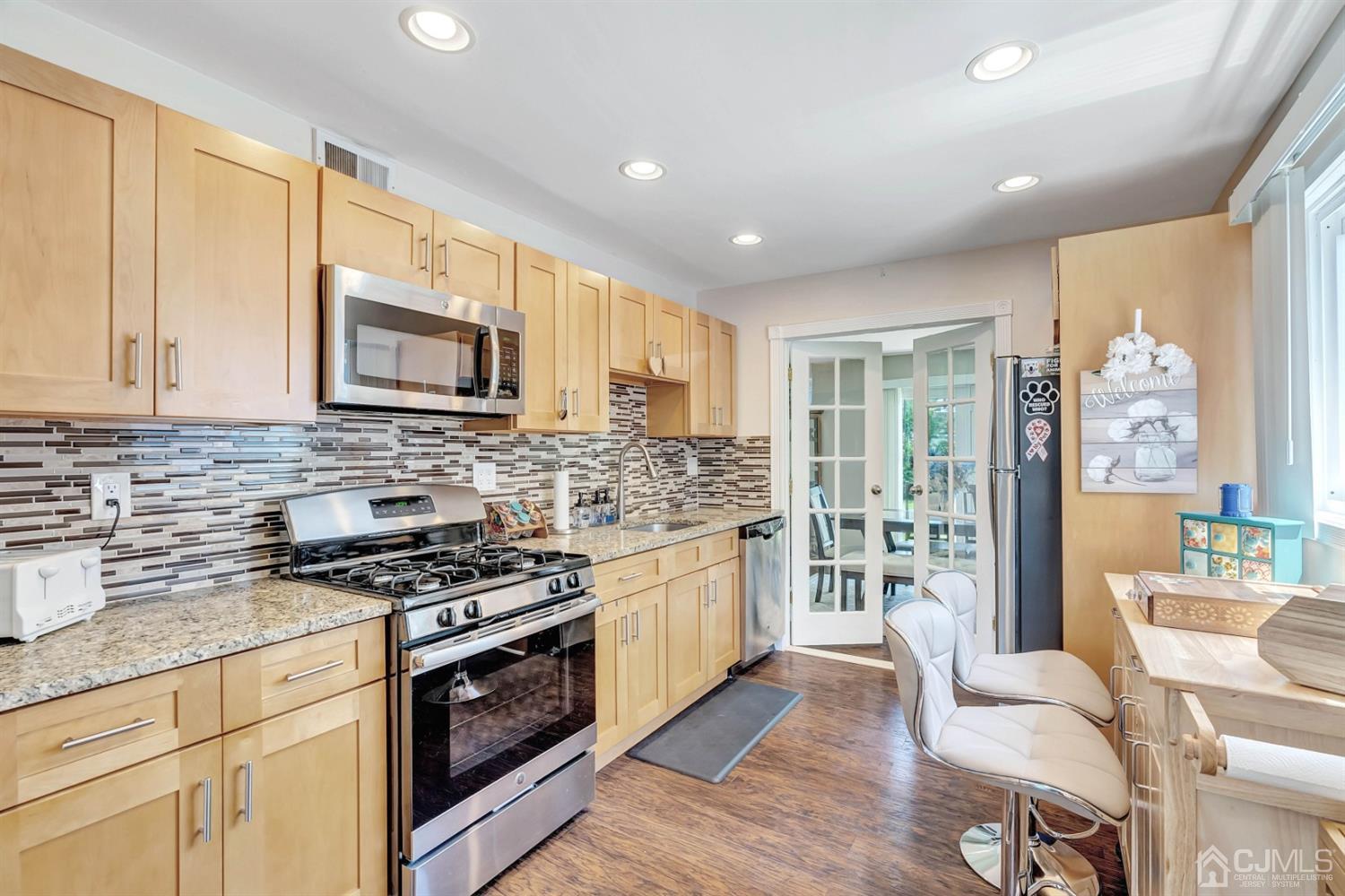 30 West Knollwood Road Edison, NJ 08817 - Photo 7 of 17 a kitchen with stainless steel appliances a stove a sink cabinets and a wooden floor