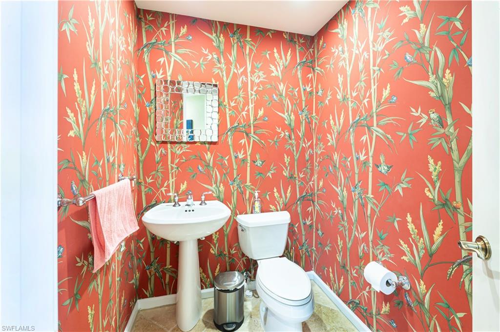 455 Cove Tower Drive, Unit 1101 Naples, FL 34110 - Photo 17 of 49 a bathroom with a sink and a mirror