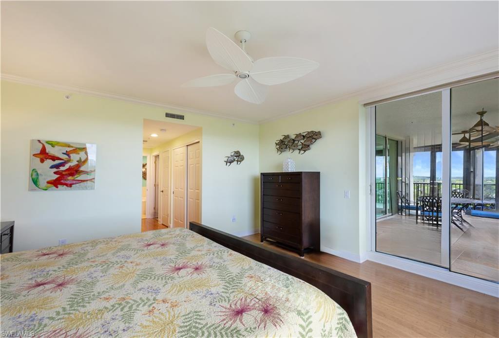 455 Cove Tower Drive, Unit 1101 Naples, FL 34110 - Photo 20 of 49 a bedroom with a bed and a painting on the wall