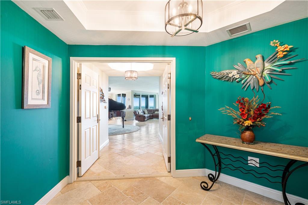 455 Cove Tower Drive, Unit 1101 Naples, FL 34110 - Photo 4 of 49 a view of a room with a table and a potted plants